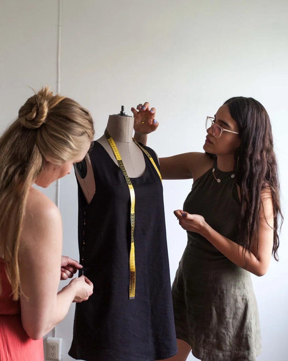Designers checking a garment sample on a dress form